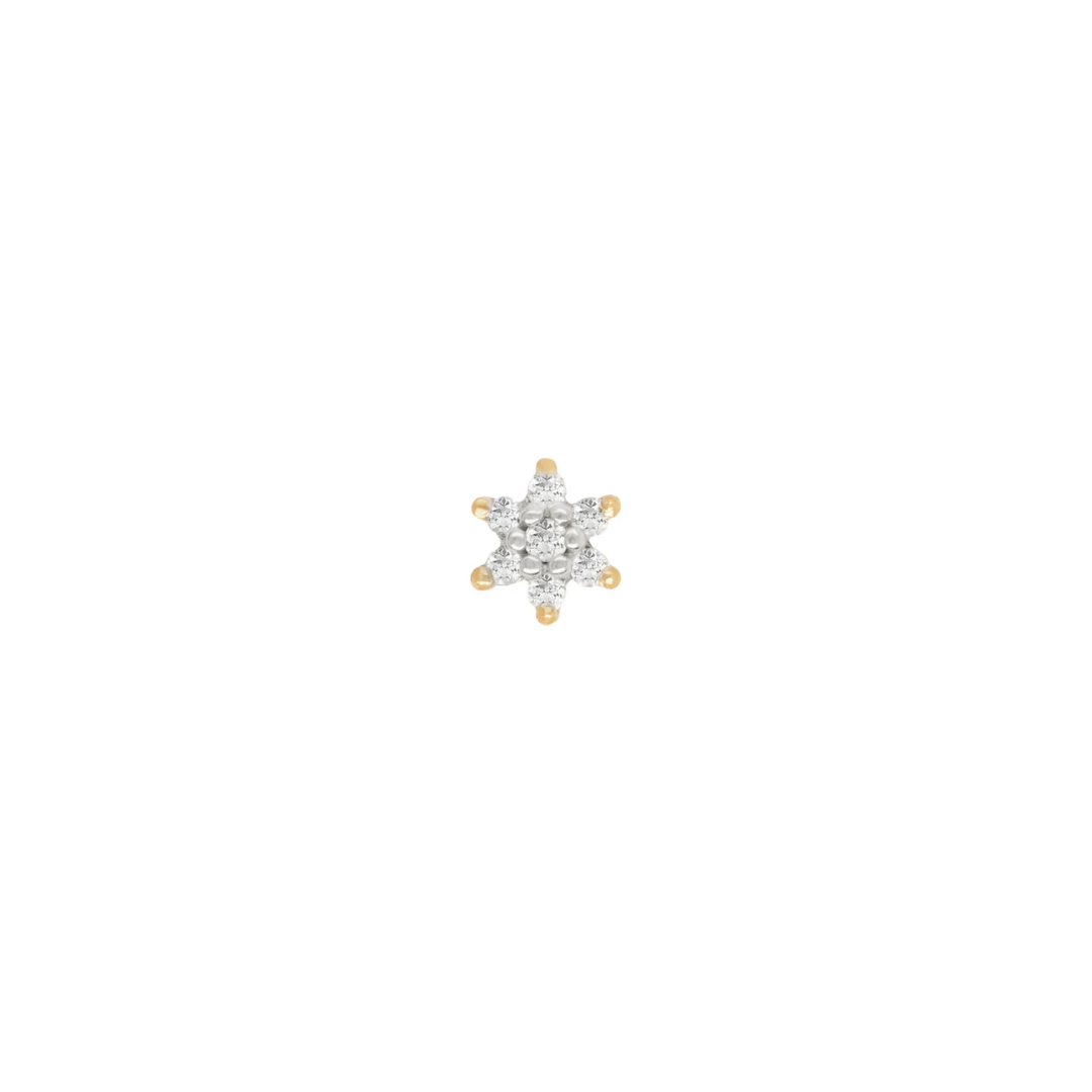 Close-up image of a 14k gold cluster body piercing end in a starburst flower design, featuring multiple sparkling diamond stones, designed for luxury ear piercings such as helix, tragus, and conch.