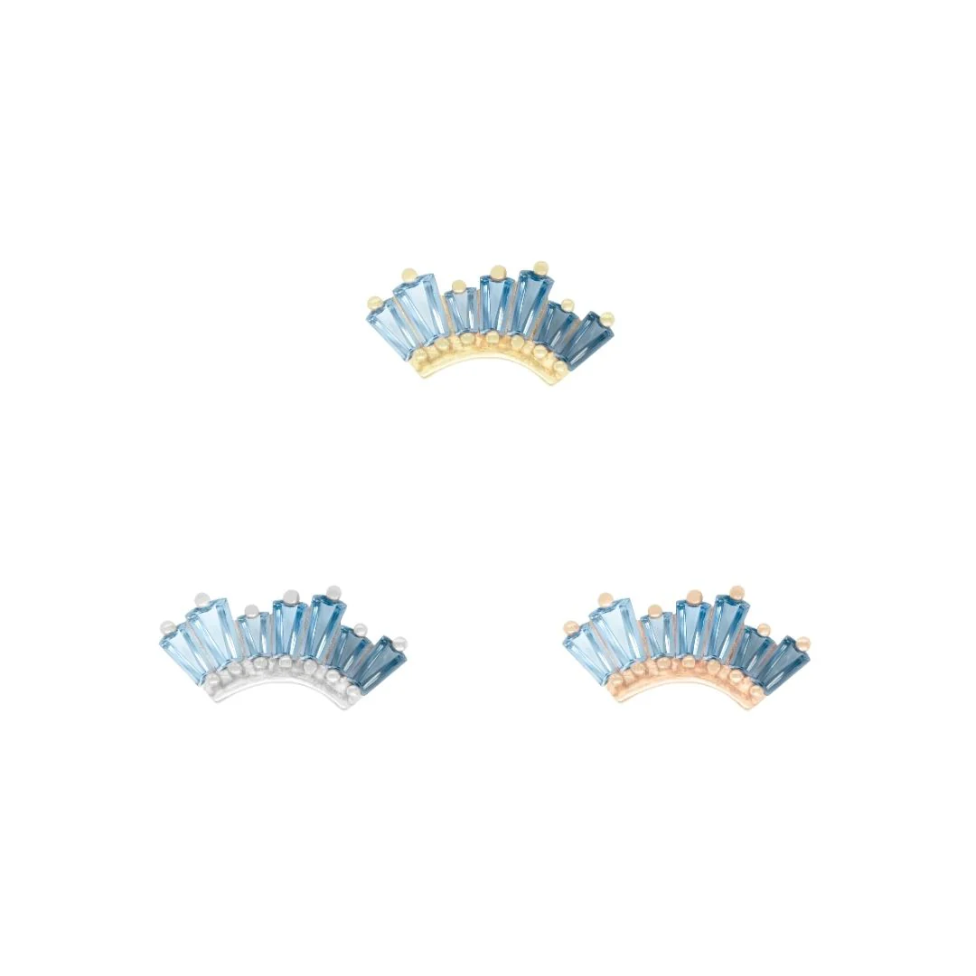 14k gold threadless piercing attachment with a fan-shaped arc of baguette-cut blue topaz stones in an ombré gradient, suitable for conch, flat, or helix piercings