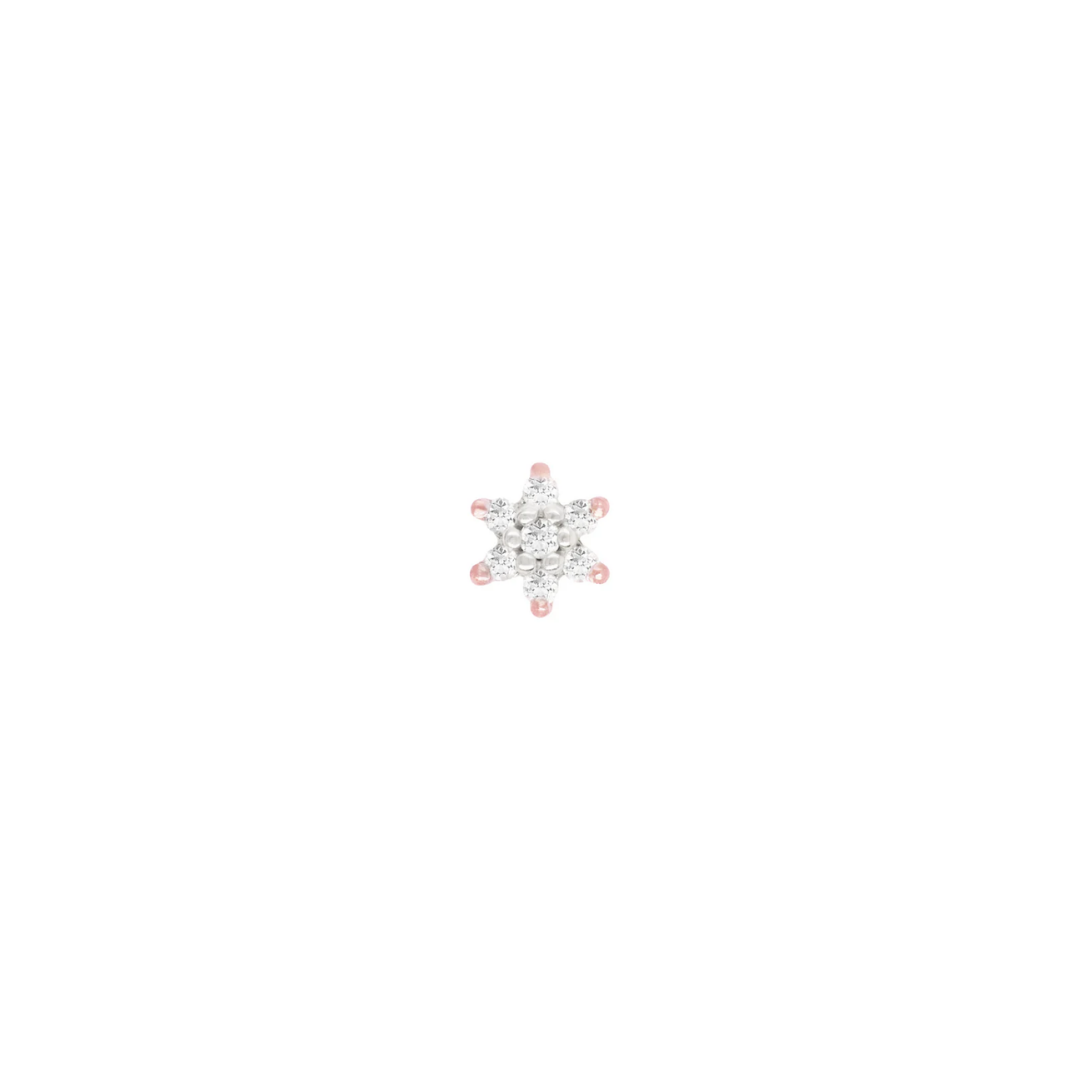 Close-up image of a 14k gold cluster body piercing end in a starburst flower design, featuring multiple sparkling diamond stones, designed for luxury ear piercings such as helix, tragus, and conch.