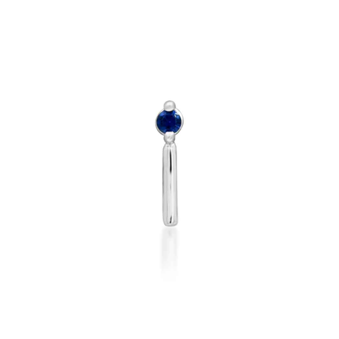14k gold piercing end featuring a deep blue round-cut cubic zirconia stone with a sleek vertical gold bar accent