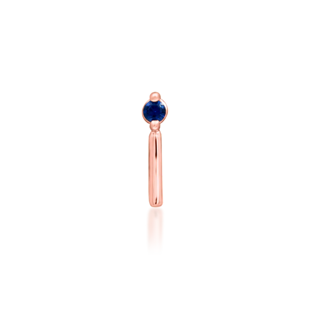 14k gold piercing end featuring a deep blue round-cut cubic zirconia stone with a sleek vertical gold bar accent
