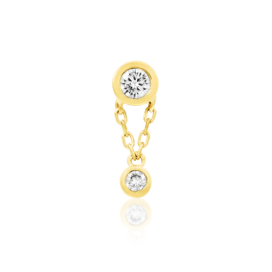 Very shiny 14k gold body jewellery featuring two bezel-set round clear cubic zirconia stones connected by a delicate gold chain. A refined, minimalist design perfect for helix, flat, or lobe piercings