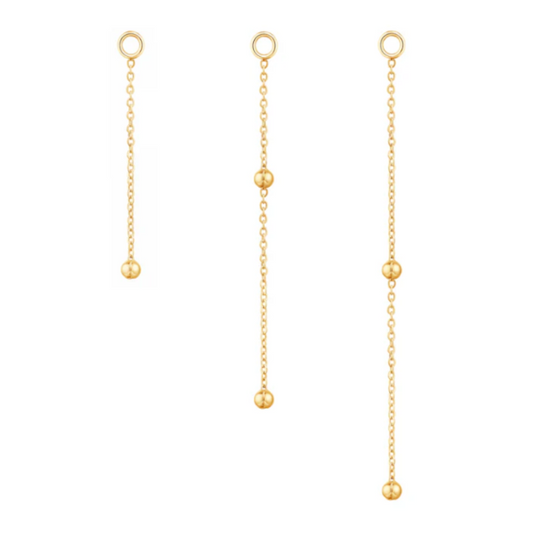 Quetzalli Cute Bead chain crafted from solid 14k gold, designed with a fine link structure and adorned with polished gold beads spaced along the length. Available in multiple lengths and gold tones, this elegant connector adds soft movement and refined texture between piercings.