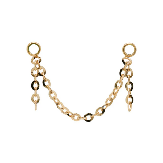 Close-up of a Quetzalli Double Dangle Chain made from solid gold, featuring two tiers of delicate oval links joined by circular ends, designed to drape elegantly between piercings.