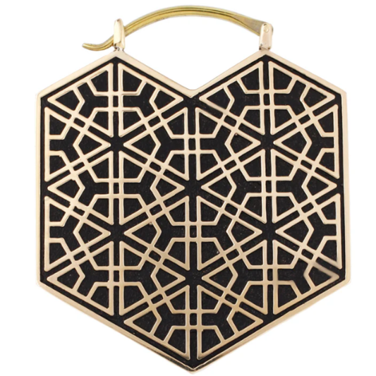 Quetzalli Ikal hoop earring crafted from yellow brass with a black inlay and anodised titanium clasp, featuring a geometric heart shape with intricate linework, displayed on a white background.