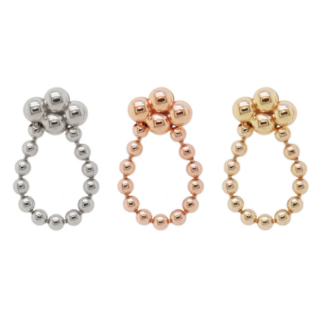 Three Quetzalli Sweet threadless ends in 14k yellow, rose, and palladium white gold, each featuring a polished beaded oval loop with a cluster of three beads at the top, photographed against a white background.