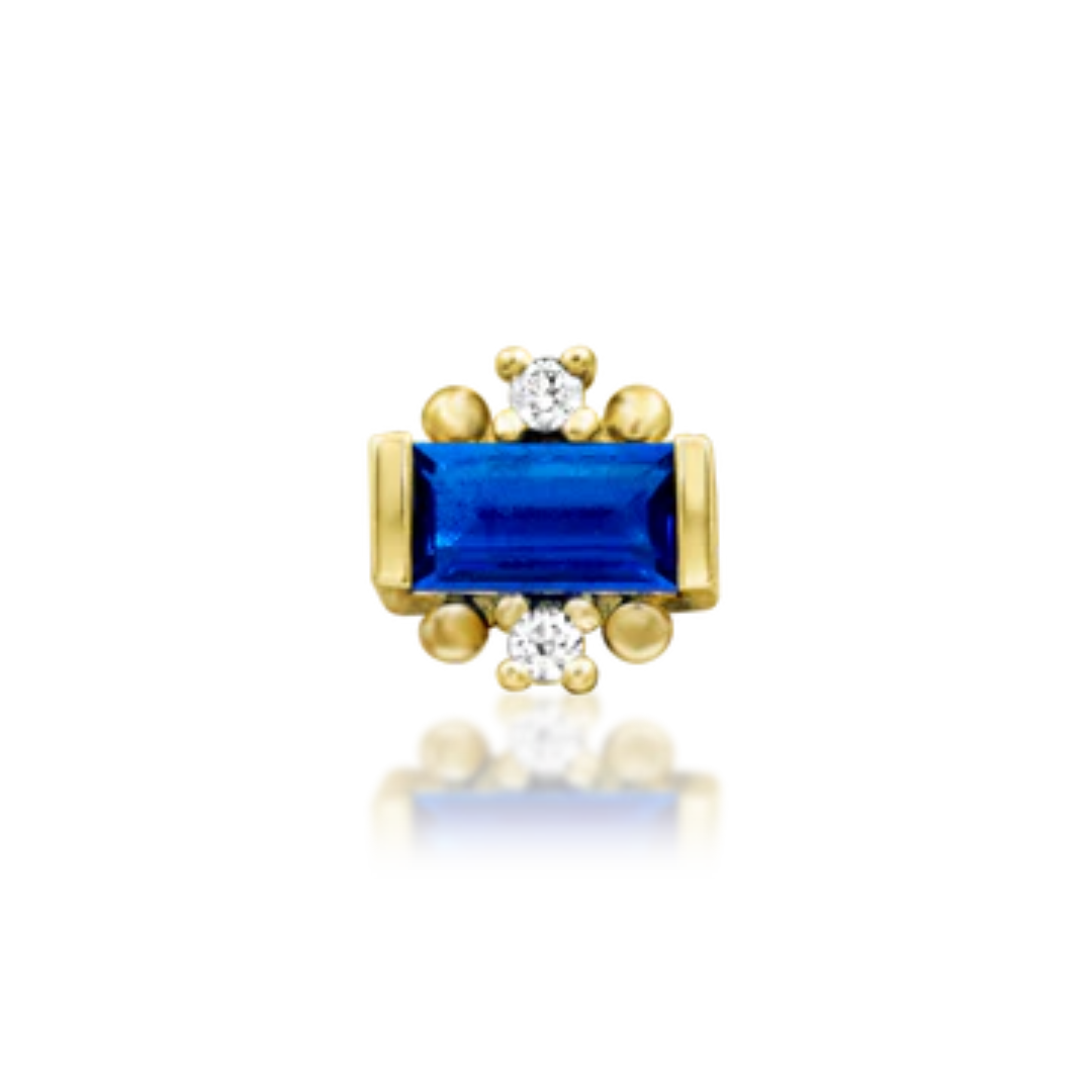 14k gold piercing jewellery featuring a vibrant blue baguette-cut gemstone flanked by two small white cubic zirconia stones and gold bead accents