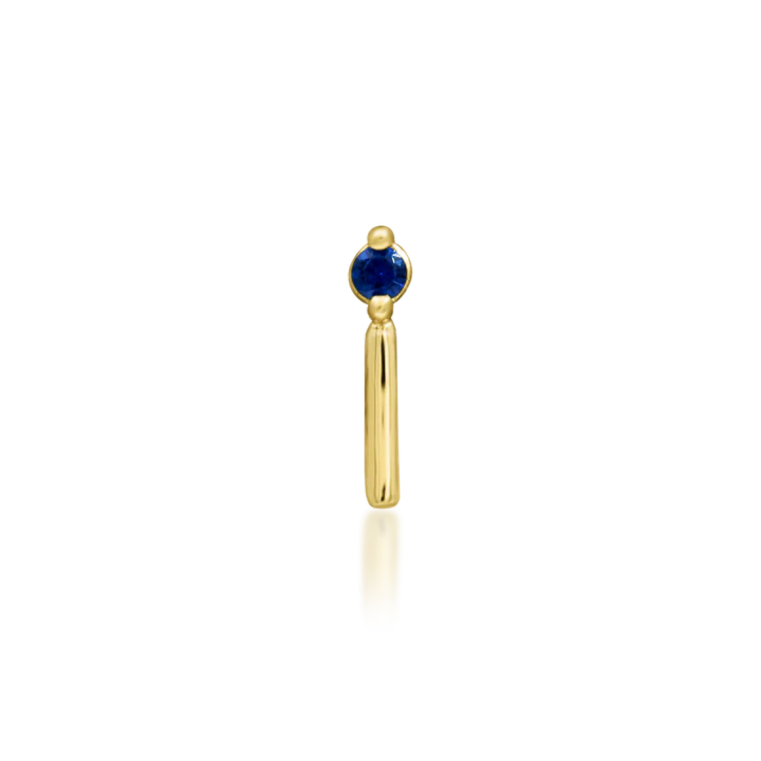 14k gold piercing end featuring a deep blue round-cut cubic zirconia stone with a sleek vertical gold bar accent