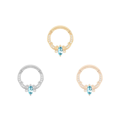 14k gold Coterie clicker ring with marquise cut London Blue Topaz and clear accent stones, shown in yellow gold, white gold, and rose gold