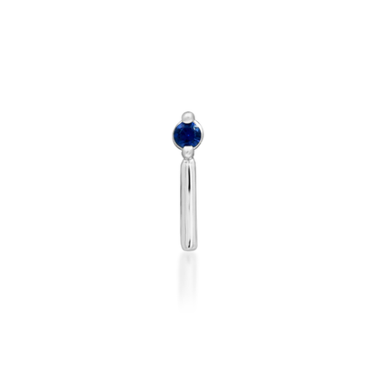 14k gold piercing end featuring a deep blue round-cut cubic zirconia stone with a sleek vertical gold bar accent
