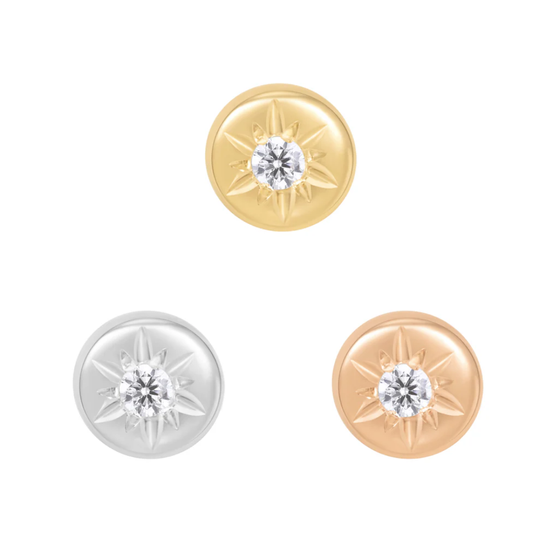 round Lark threadless ends featuring a central clear CZ stone set in a compass starburst design, shown in yellow gold, white gold, and rose gold