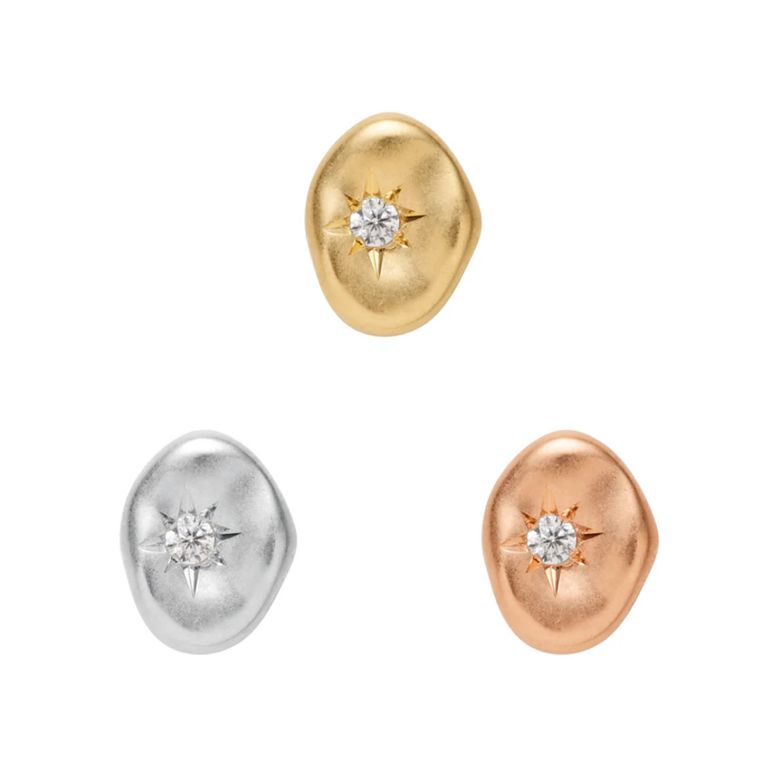 Organic pebble-shaped threadless ends with a central CZ starburst detail, available in yellow, white, and rose gold finishes.