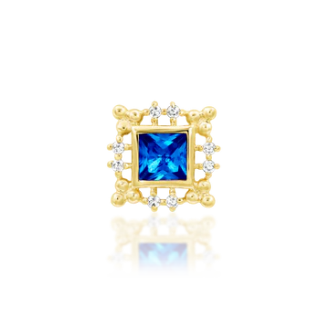 Gold square piercing end with ornate frame and a vibrant blue sapphire centre surrounded by white CZ accents