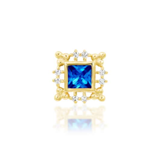 Gold square piercing end with ornate frame and a vibrant blue sapphire centre surrounded by white CZ accents