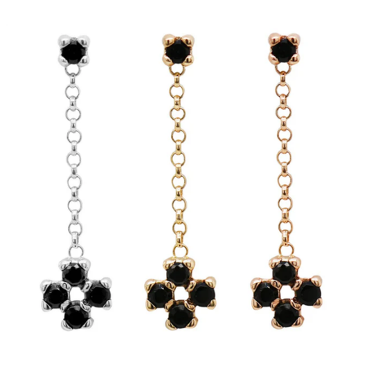 Three Quetzalli Soul Charmer chains in 14k yellow, rose, and palladium white gold, each featuring faceted black spinel gemstones arranged in a small floral cluster at the base of a fine chain, photographed against a white background.