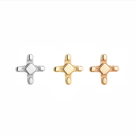 Three Quetzalli Spark threadless ends in 14k yellow, rose, and palladium white gold, each featuring a geometric cross design with a polished central facet and rounded tips, displayed against a white background.