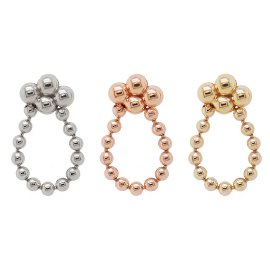 Three Quetzalli Sweet threadless ends in 14k yellow, rose, and palladium white gold, each featuring a polished beaded oval loop with a cluster of three beads at the top, photographed against a white background.