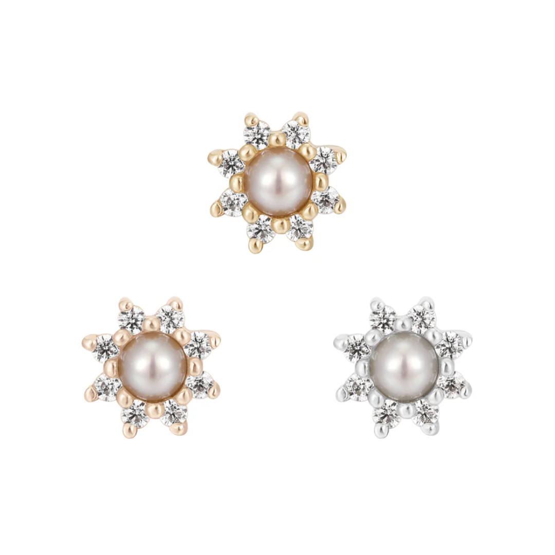 Gold threadless end featuring a luminous pearl surrounded by a halo of white CZs in a starburst setting.