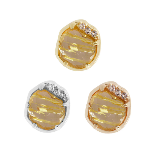 Gold threadless end featuring a round rutilated quartz stone with golden needle-like inclusions, framed in an organic bezel with CZ accents.